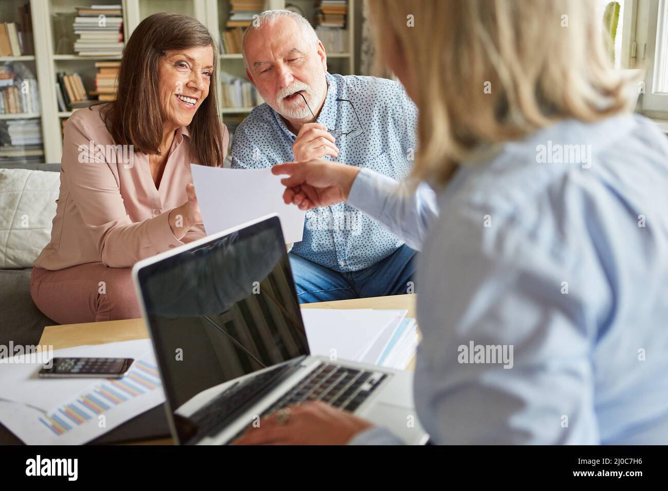 Financial advisor and senior couple with an offer to finance care and retirement planning Stock Photo