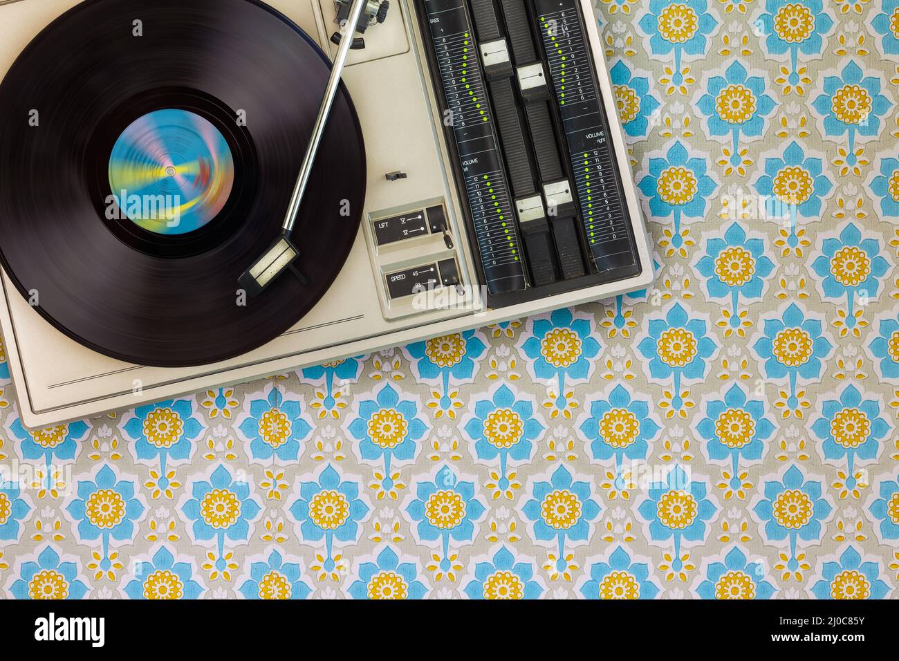 Old record player on top of flower wallpaper Stock Photo