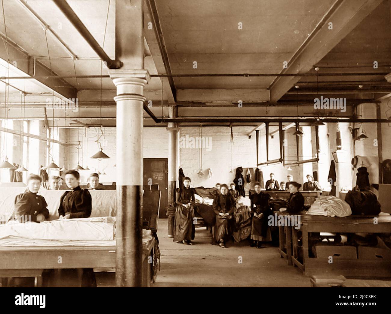 Burling and mending pieces in a woollen mill in Bradford, Yorkshire