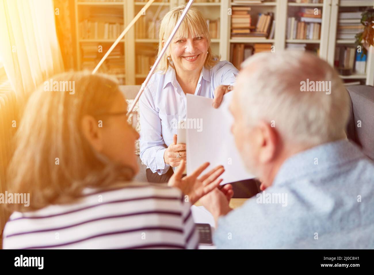 Couple of seniors gets a contract for the provision of counseling at home Stock Photo