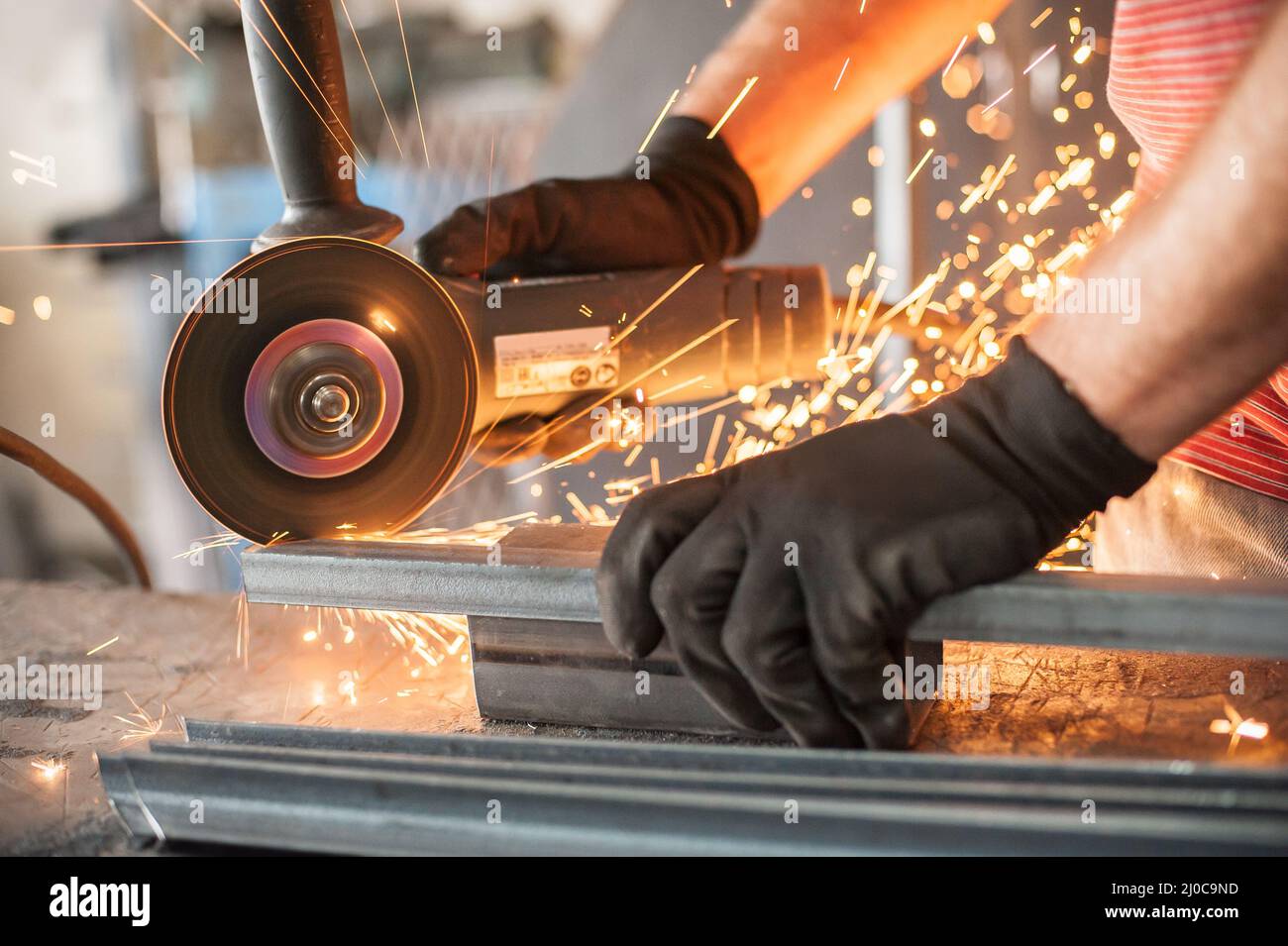 Electric wheel grinding on steel structure in factory. Sparks from the