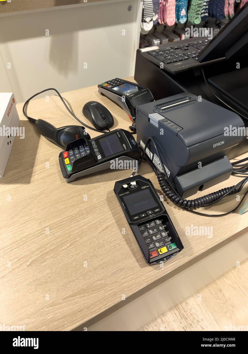 Karlsruhe, Germany - March 12, 2022: Multiple Ingenico Pos terminals near  the cash register in clothes store - Epson printer for the paper slip and  Honeywell barcode reader scanner Stock Photo - Alamy