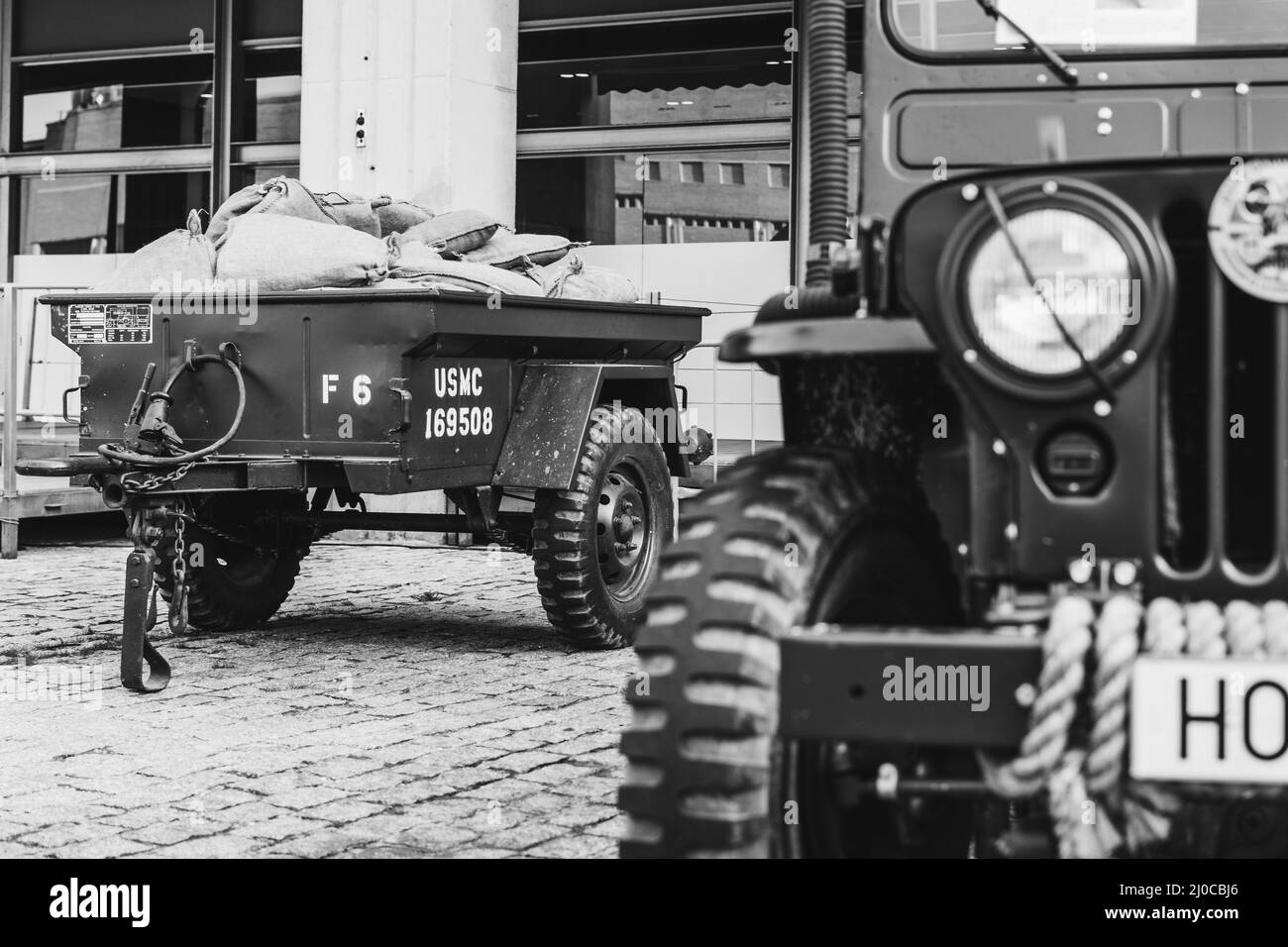 Closeup shot of a historical car Jeep Willys M38 driving in the town