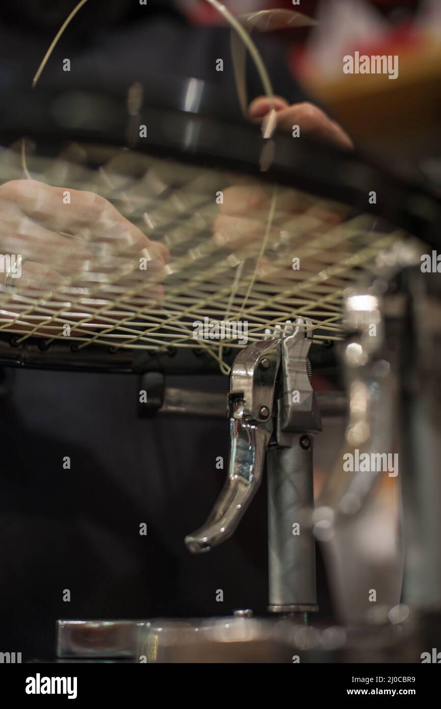 Racket stringing. Detail of tennis racket in the stringing machine