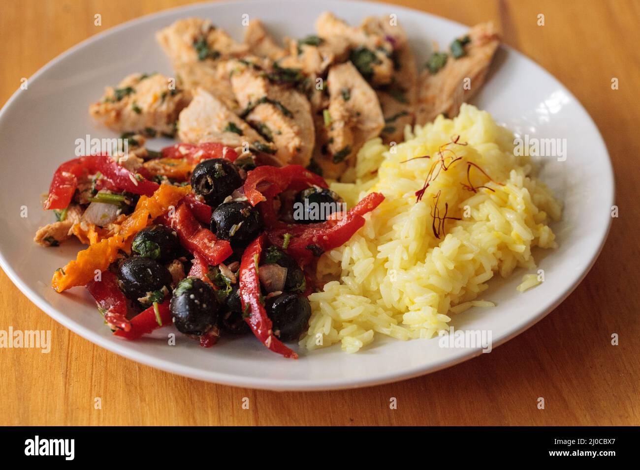 Spicy Chicken Diablo with cilantro, olives, peppers, garlic and onion Stock Photo