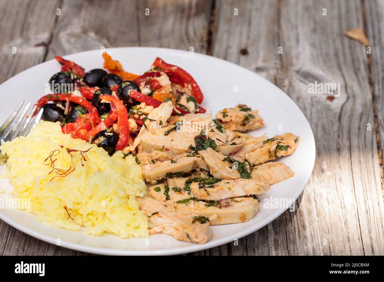 Spicy Chicken Diablo with cilantro, olives, peppers, garlic and onion Stock Photo