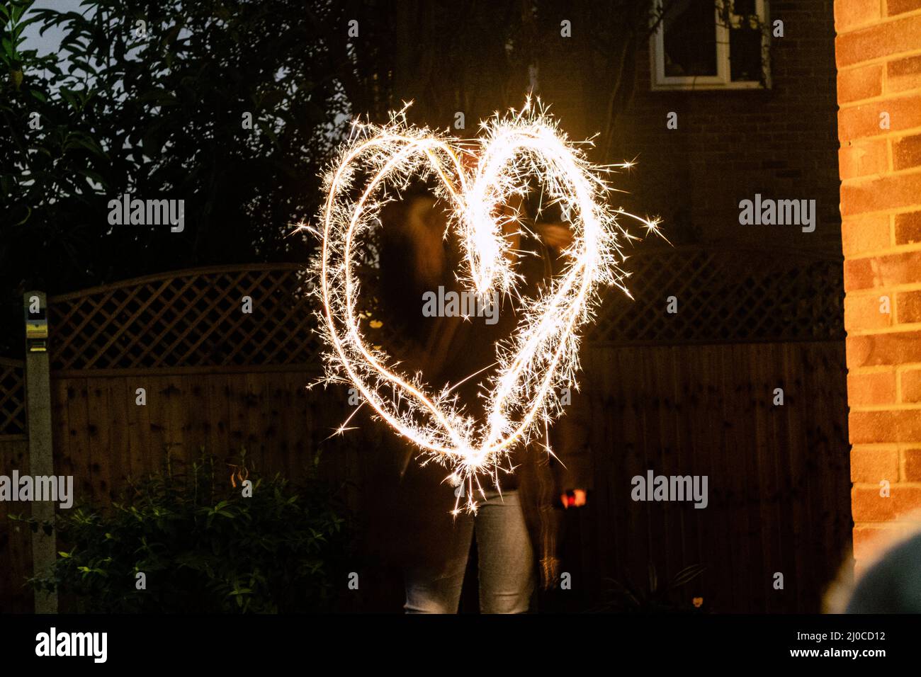 Large heart drawn out with a sparkler Stock Photo