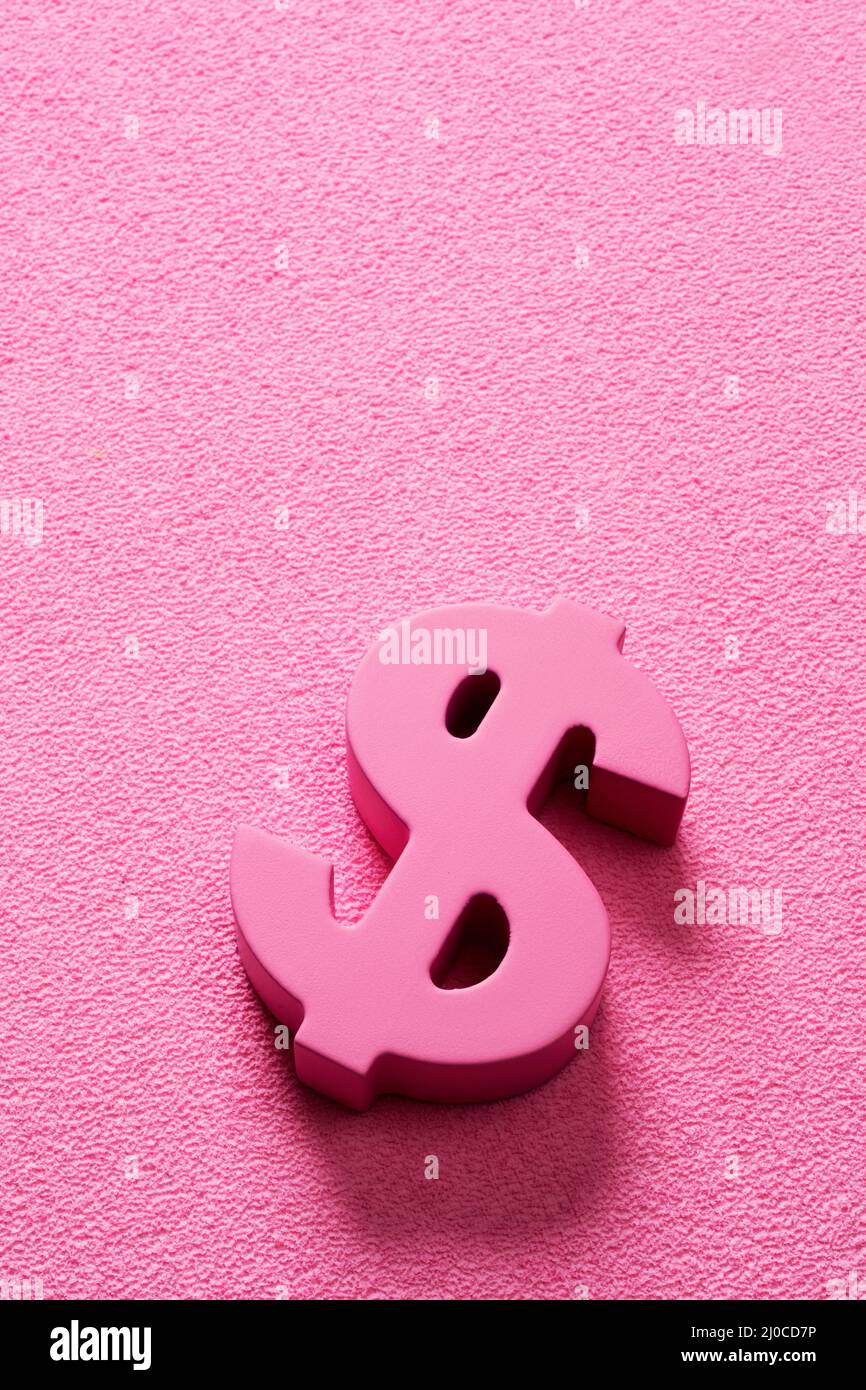 a pink dollar sign on a pink background with some blank space on top, to depict the pink money or pink capitalism concepts Stock Photo