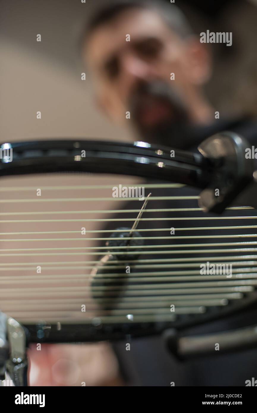 Racket stringing. Detail of tennis racket in the stringing machine