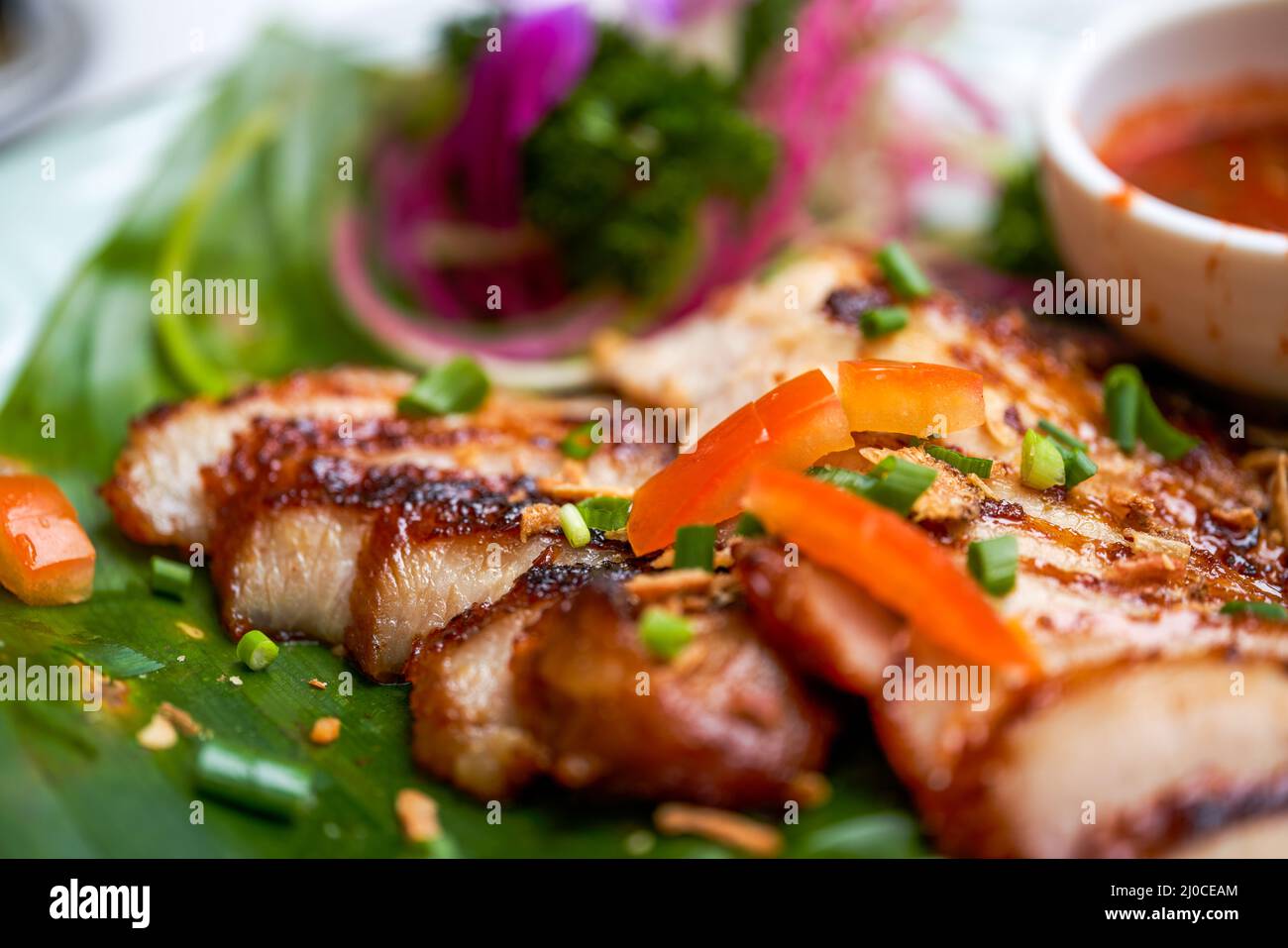 A plate of crispy and delicious roasted pork neck with Thai chutney Stock Photo