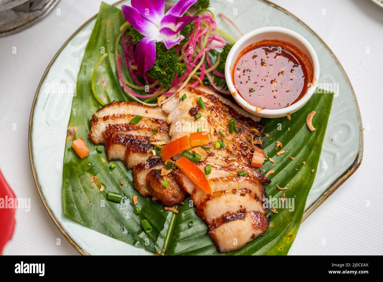 A plate of crispy and delicious roasted pork neck with Thai chutney Stock Photo