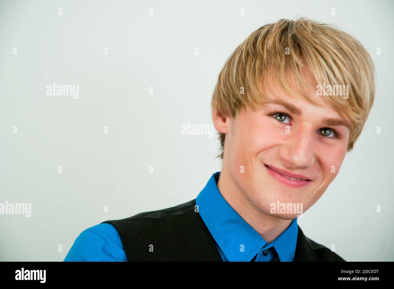 Young man smiling and looking up. Close view. Stock Photo