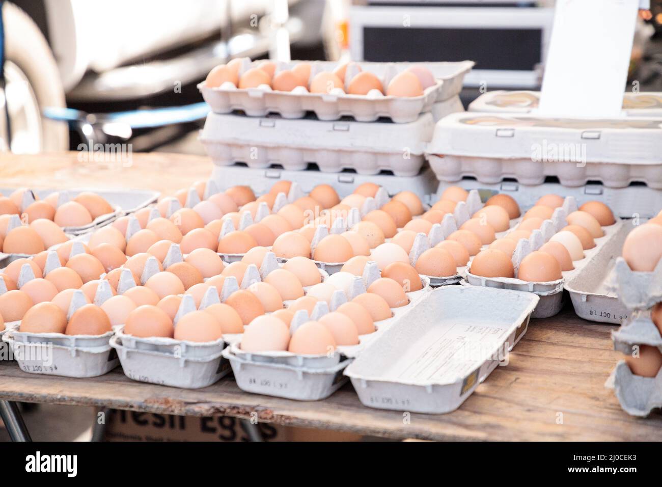 Egg Crates of brown and white eggs at a local farmers market Stock Photo