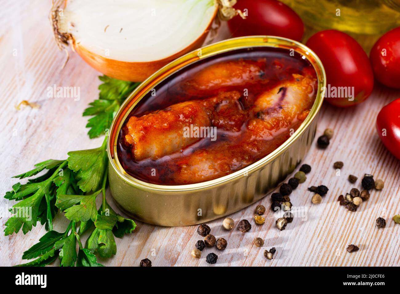 Canned stuffed squid in American sauce in open tin can, nobody Stock