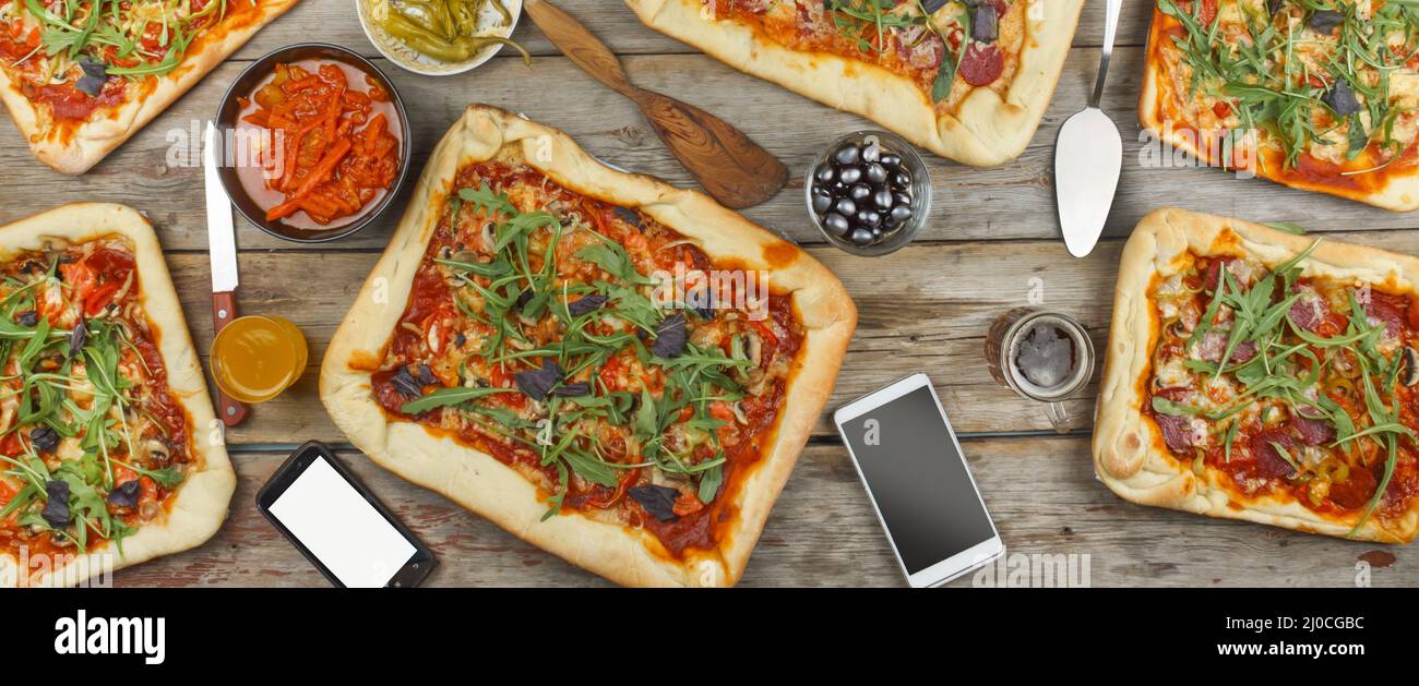 Appetizing homemade pizza on a wooden table.rustic style Friendly feast at home. Stock Photo