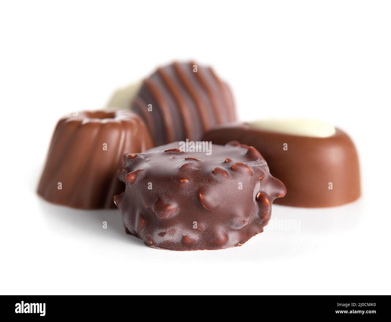 Assorted chocolate pralines or truffles. Closeup of a variety of small non uniform chocolate bonbon piece coated with dark chocolate and milk chocolat Stock Photo