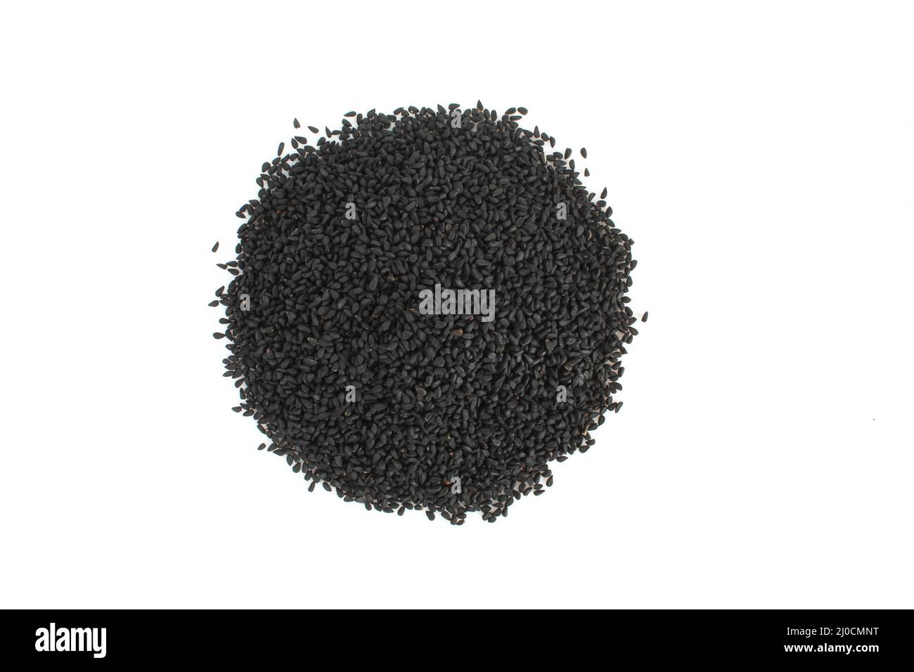 Pile of black cumin seeds isolated on white background. Nigella sativa Stock Photo