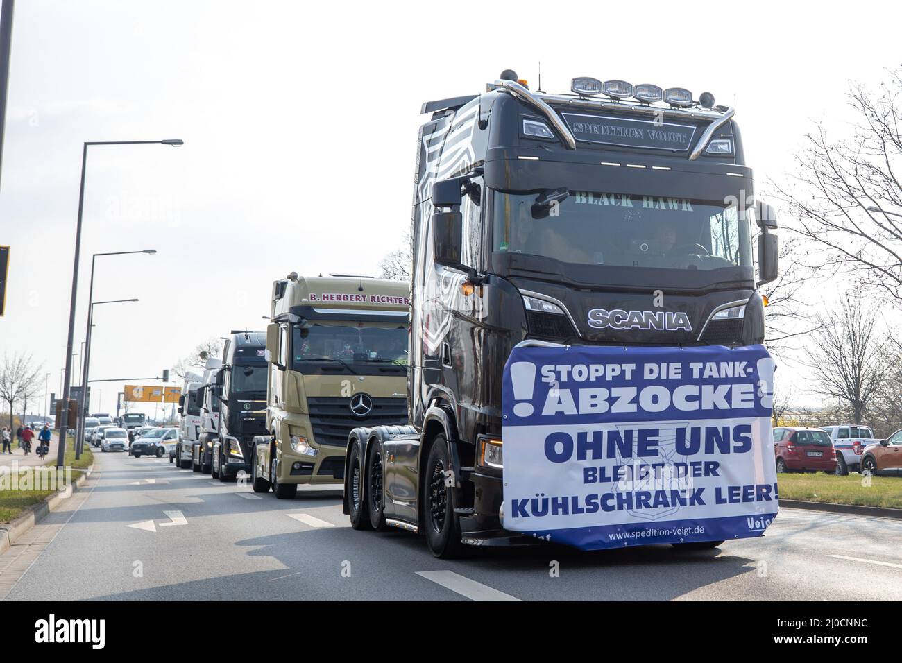 Dresden, Germany. 18th Mar, 2022. On a truck is a banner with the text 'STOP THE ABZOCKE WITHOUT US BLEIBT THE KÜHLSCHRANK EMPTY!' attached. This belongs to the vehicle parade which drives through the city of Dresden and is for the lowering of the high gasoline prices and also demands a fuel price brake. The state association of the Saxon transport industry (LSV) had called for this action. Credit: Daniel Schäfer/dpa-Zentralbild/dpa/Alamy Live News Stock Photo