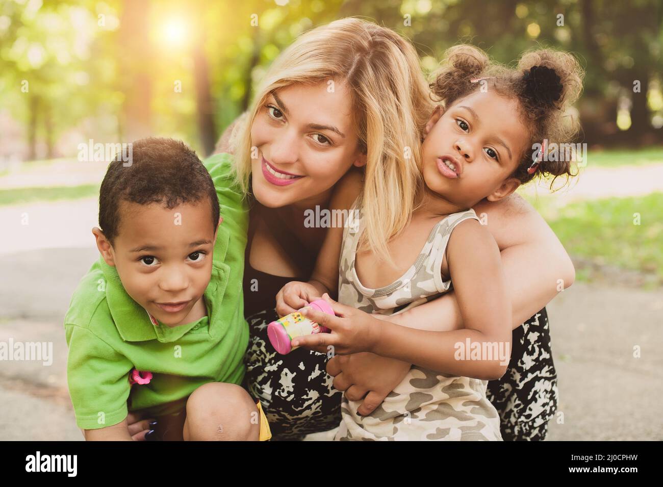 Mother, son and daughter having fun and enjoying in the park