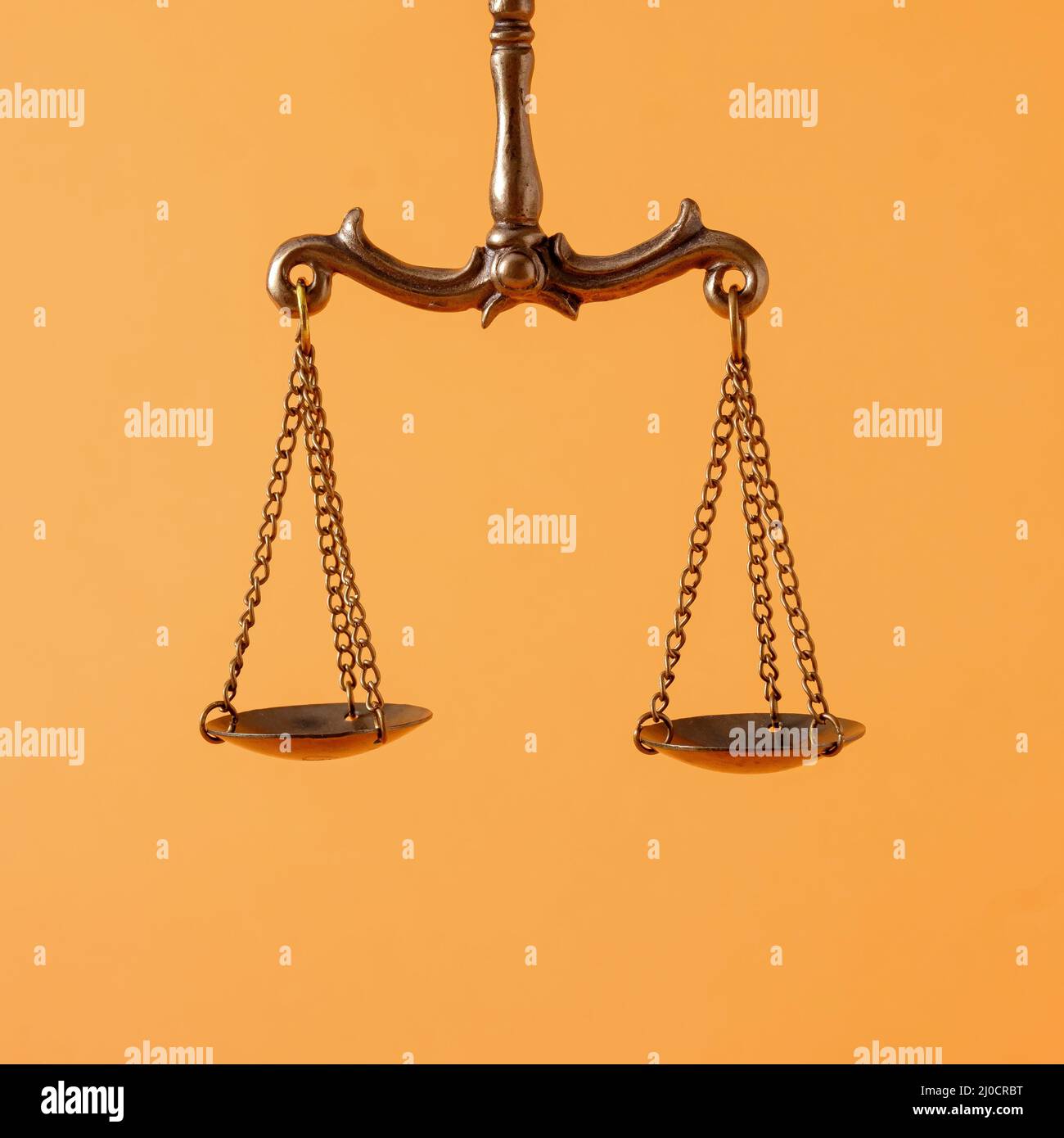 https://c8.alamy.com/comp/2J0CRBT/pendulum-scales-over-an-orange-background-with-copy-space-in-a-concept-of-law-enforcement-and-justice-2J0CRBT.jpg
