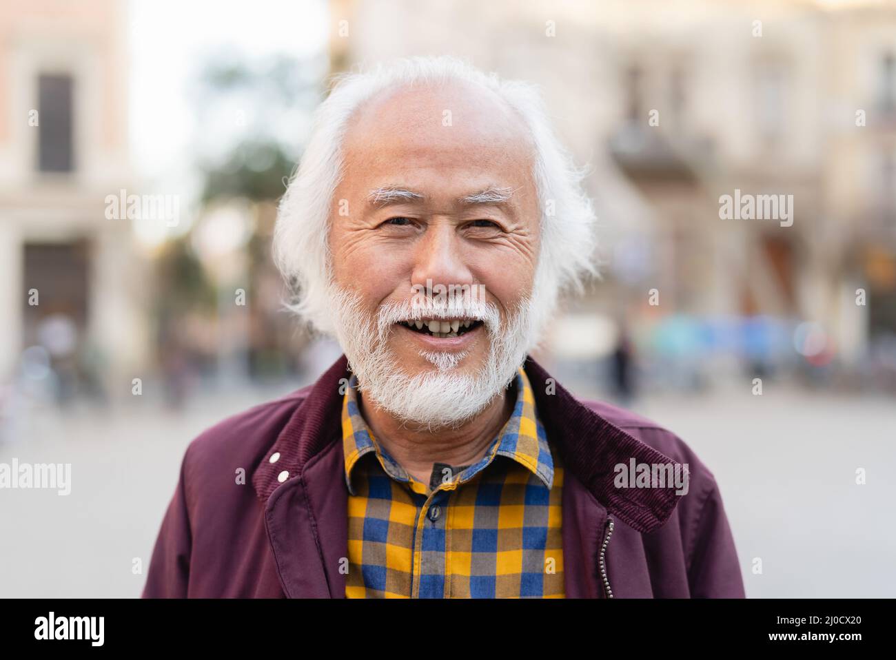 Portrait of happy Asian senior man smiling in front of camera Stock Photo