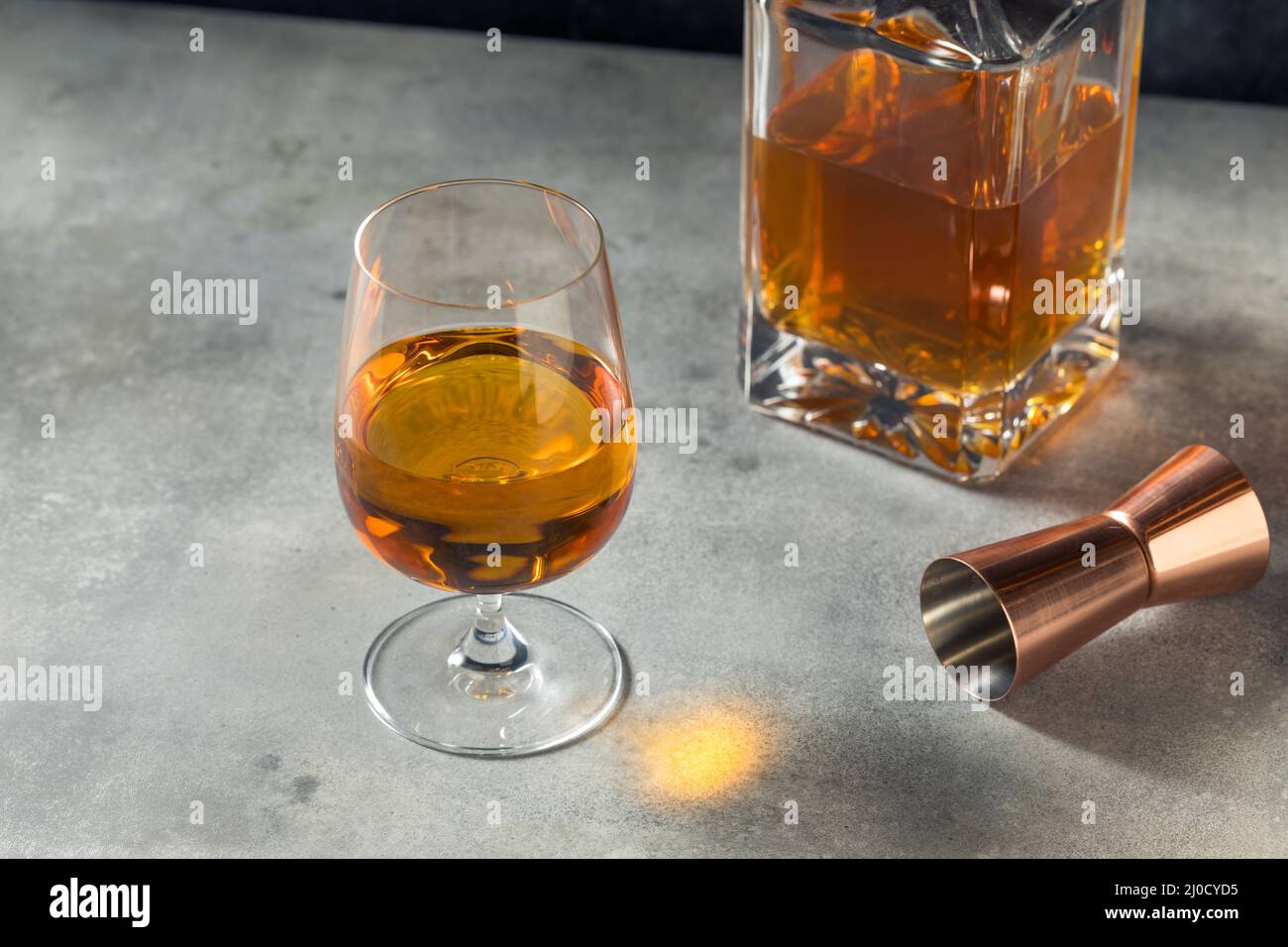 Boozy Whiskey in a Snifter Glass Ready to Drink Stock Photo Alamy