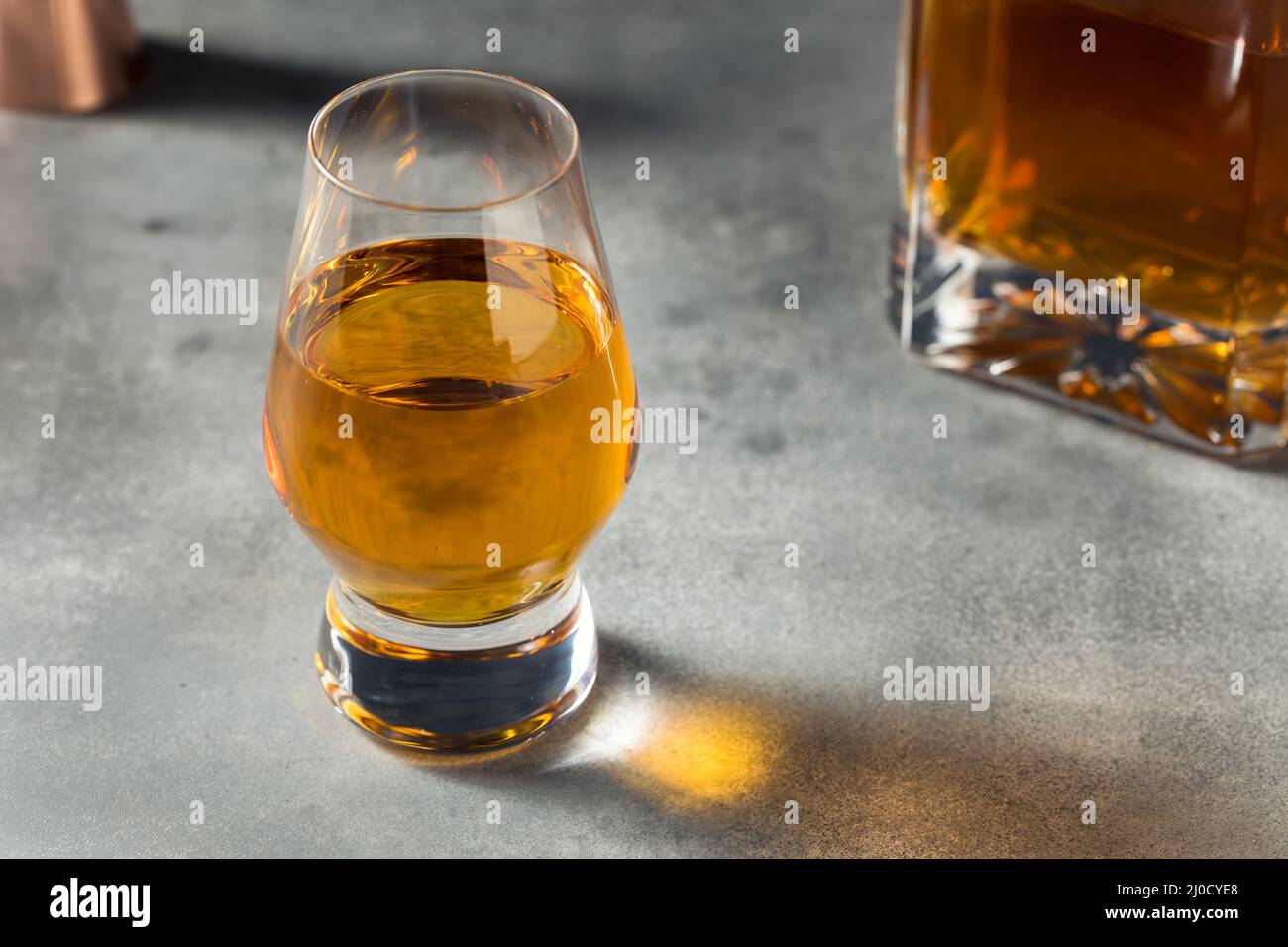 Boozy Whiskey in a Snifter Glass Ready to Drink Stock Photo
