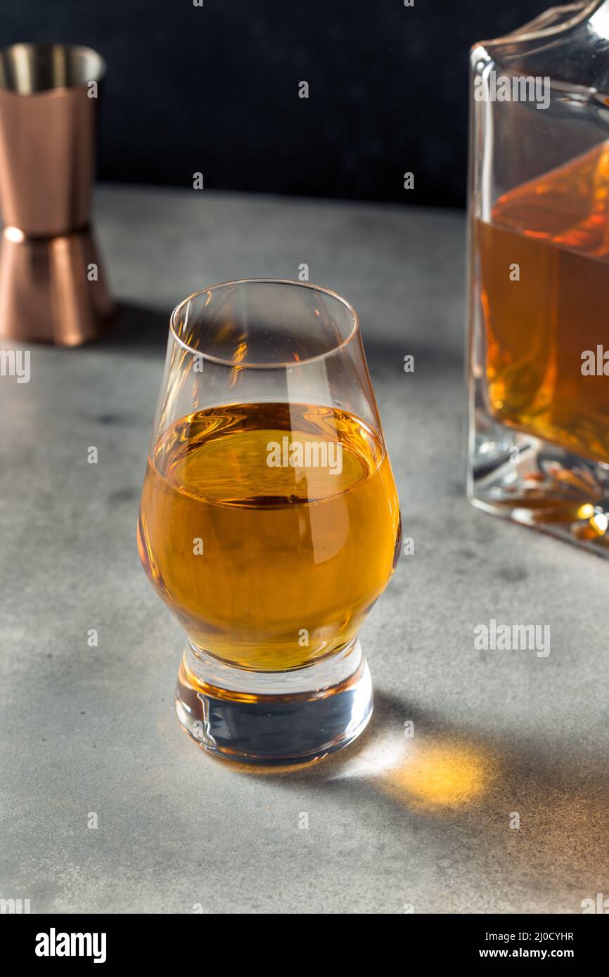 Boozy Whiskey in a Snifter Glass Ready to Drink Stock Photo Alamy