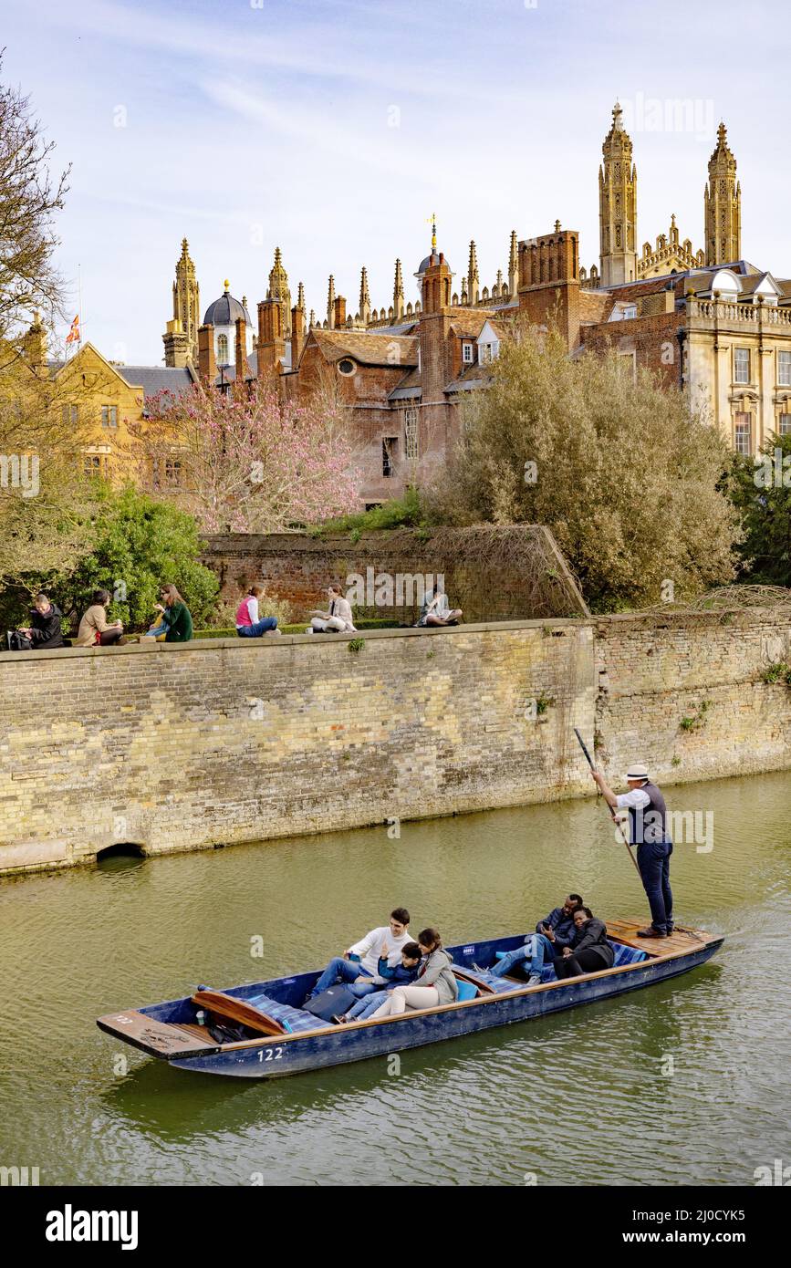Cambridge punting; Punt on the River Cam and Cambridge students sitting on the wall of Trinity Hall College, spring Cambridge University, Cambridge UK Stock Photo
