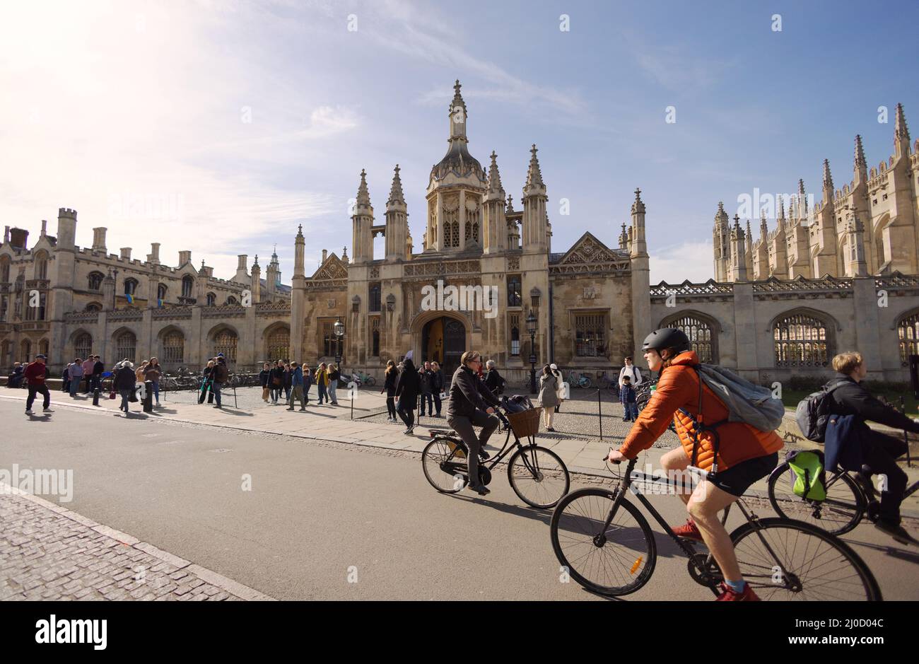 Cambridge cycling - people riding bicycles on a sunny spring day, Kings Parade, in front of Kings College , Cambridge City Centre, Cambridge UK Stock Photo