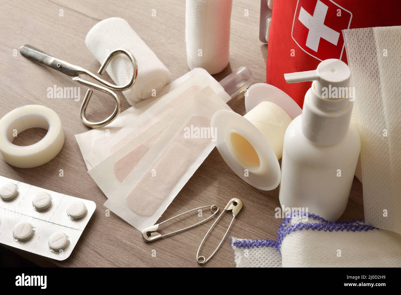 Emergency home kit on wooden table and warm room background. Horizontal composition. Elevated
