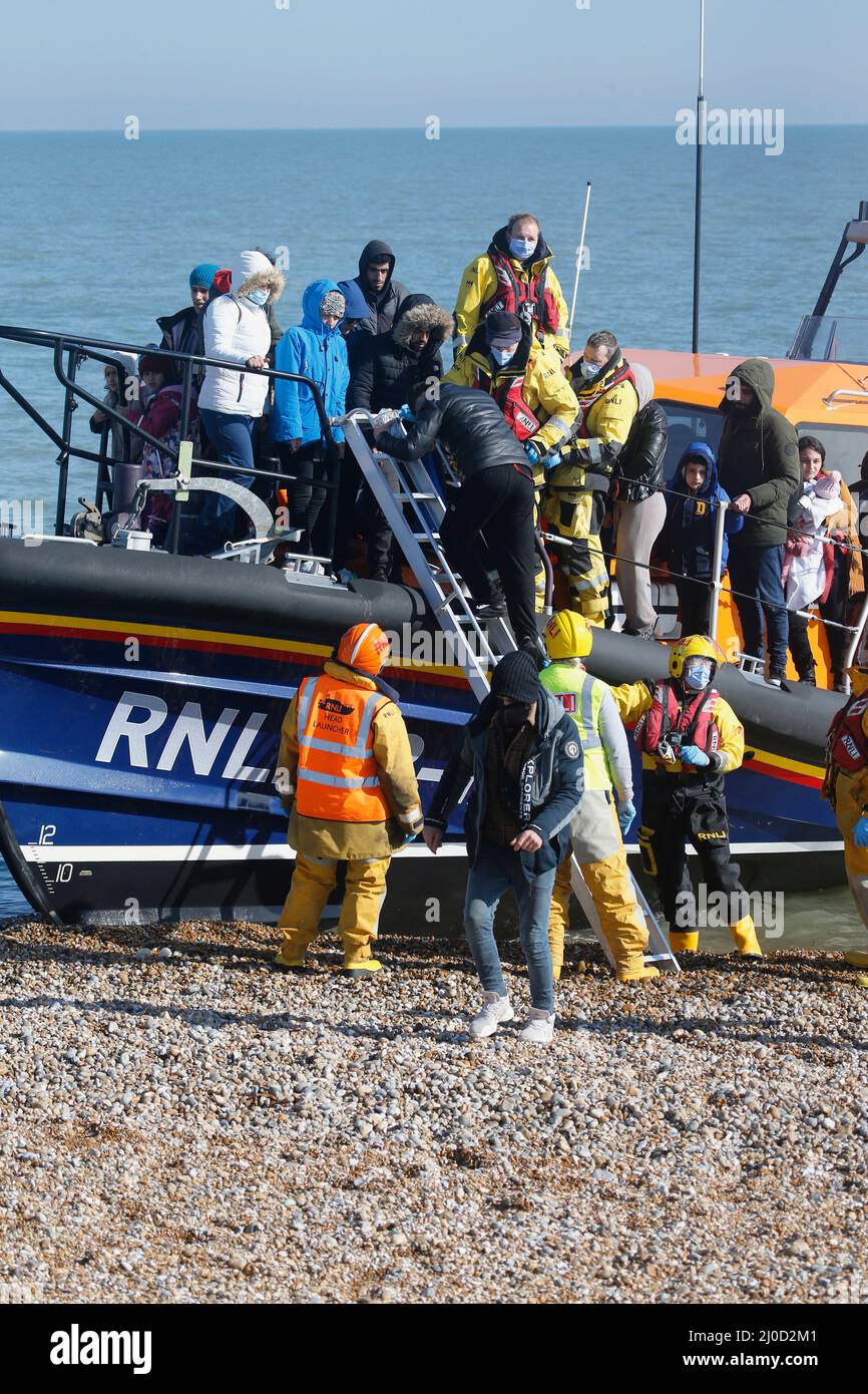 England, Kent, Dungeness, RNLI, helping migrants who have crossed the channel onto the beach. Stock Photo