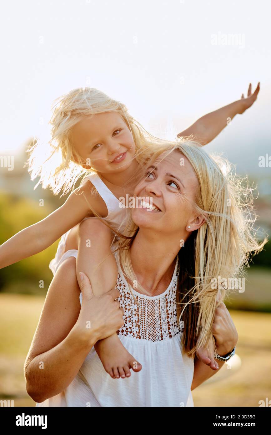 Happiness is playing with your daughter. Shot of a mother and her daughter playing outdoors. Stock Photo