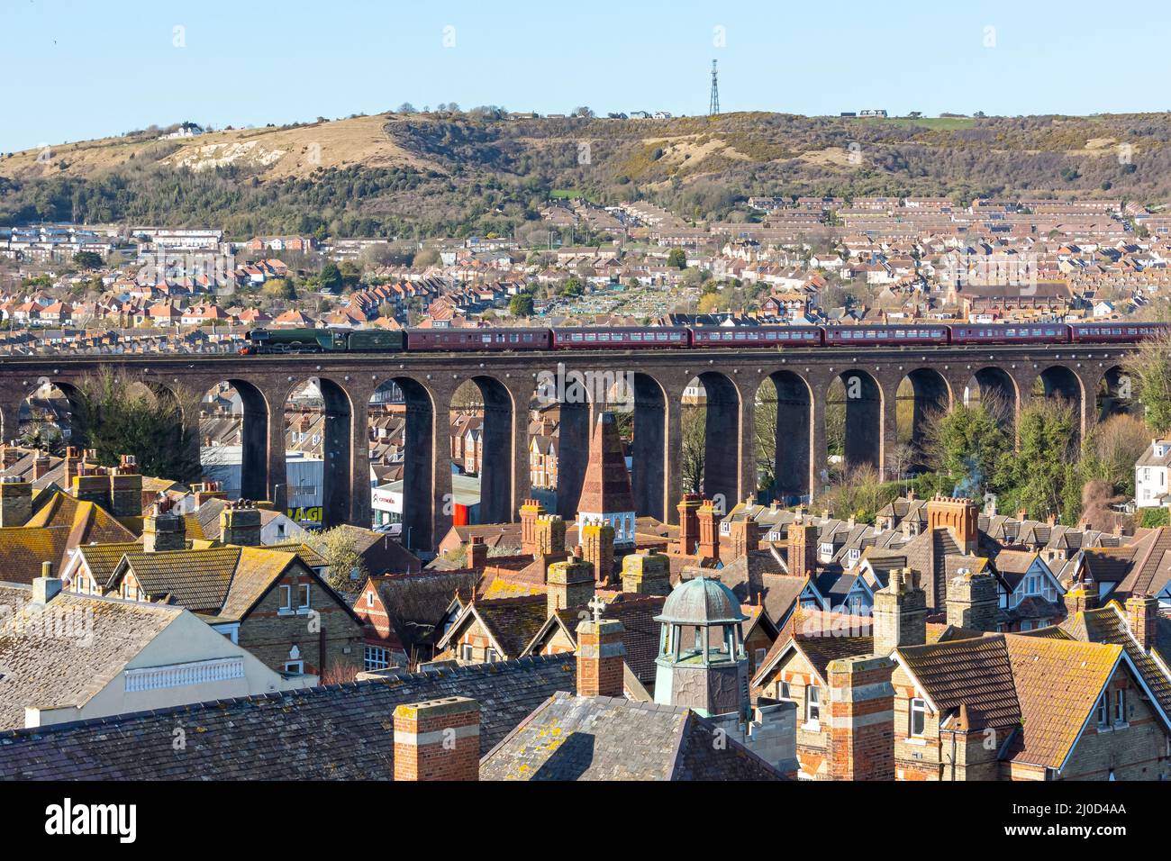 The Famous Flying Scotsman steam locomotive owned by the National Railway Museum passes over a viaduct across Folkestone, from London via Canterbury, Stock Photo