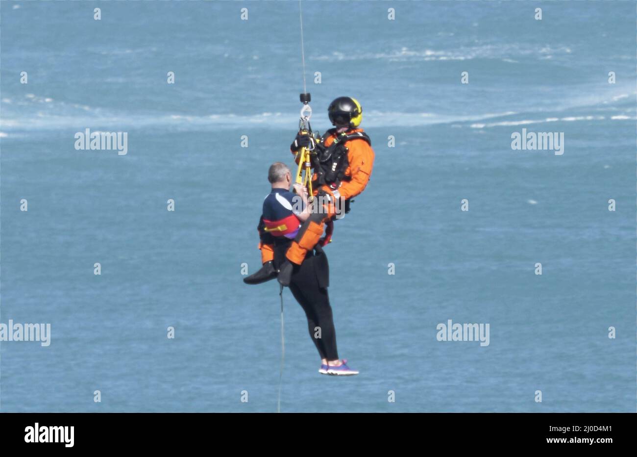 Cornwall, UK. 18th Mar, 2022. Sea rescue by helicopter for sea bather swept to cliffs. Newquay Cornwall Credit: Robert Taylor/Alamy Live News Stock Photo