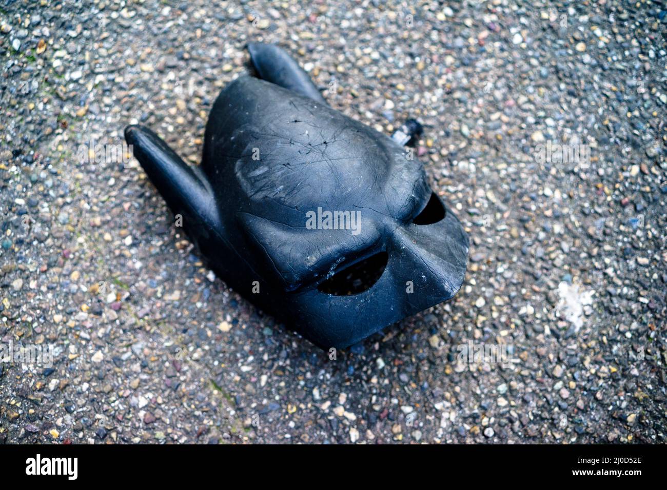 Batman mask on a concrete floor Stock Photo