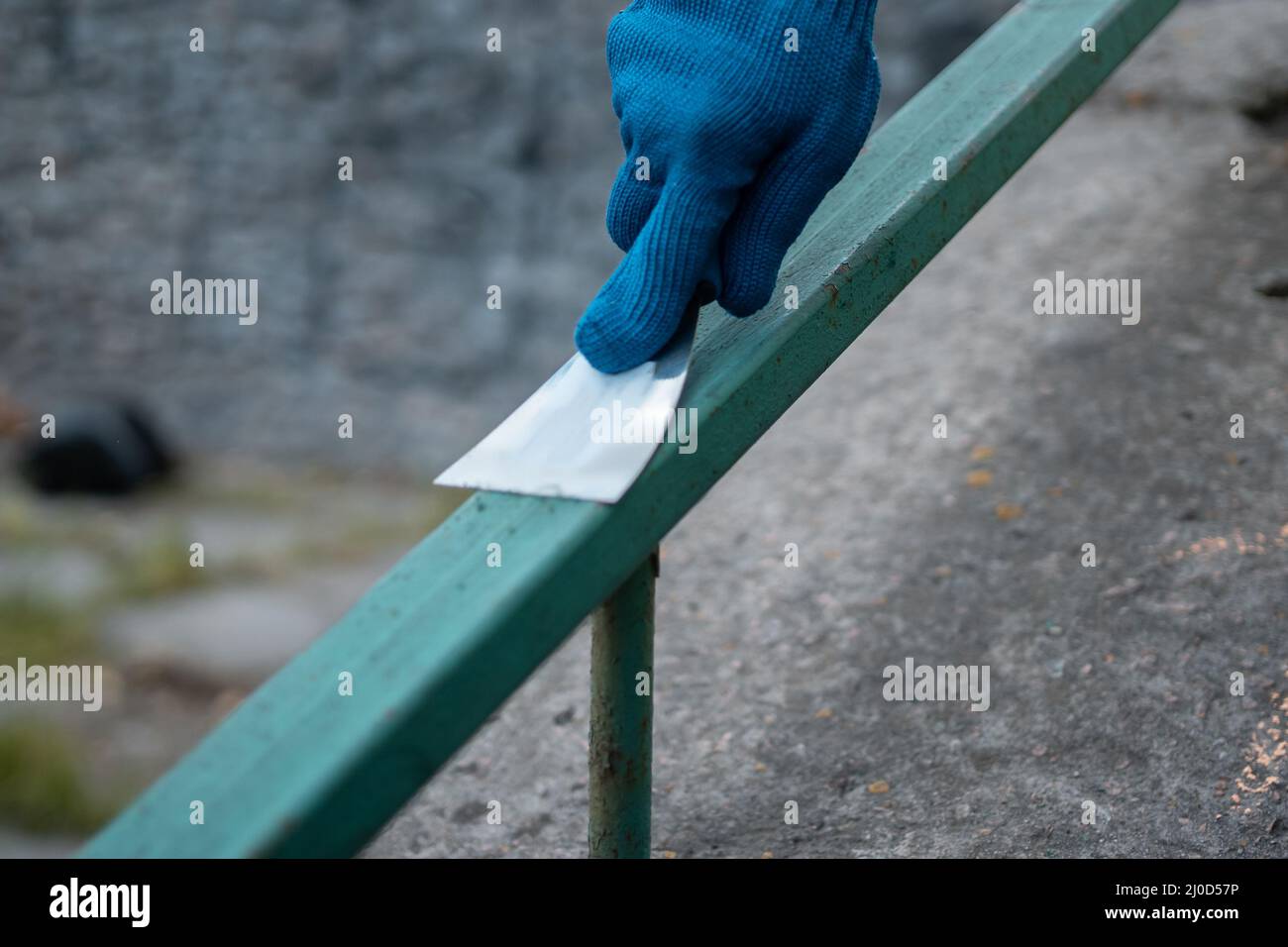 volunteer worker painting and renovate railing or fence in public park Stock Photo