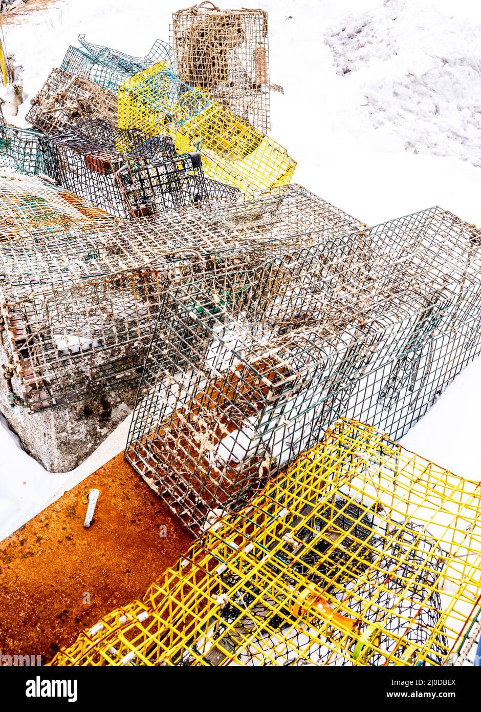 These Lobster traps once where stacked on top of one another, now all over and covered with snow. Owner could not get them before the snow storm hit. Stock Photo