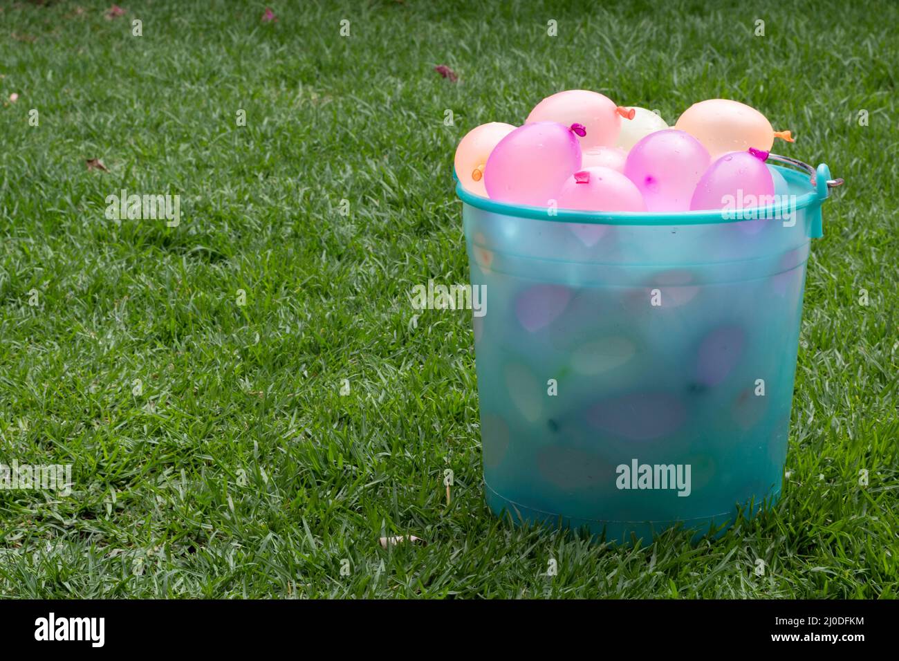 Big Bucket of FIlled Water Balloon. Copy space Stock Photo