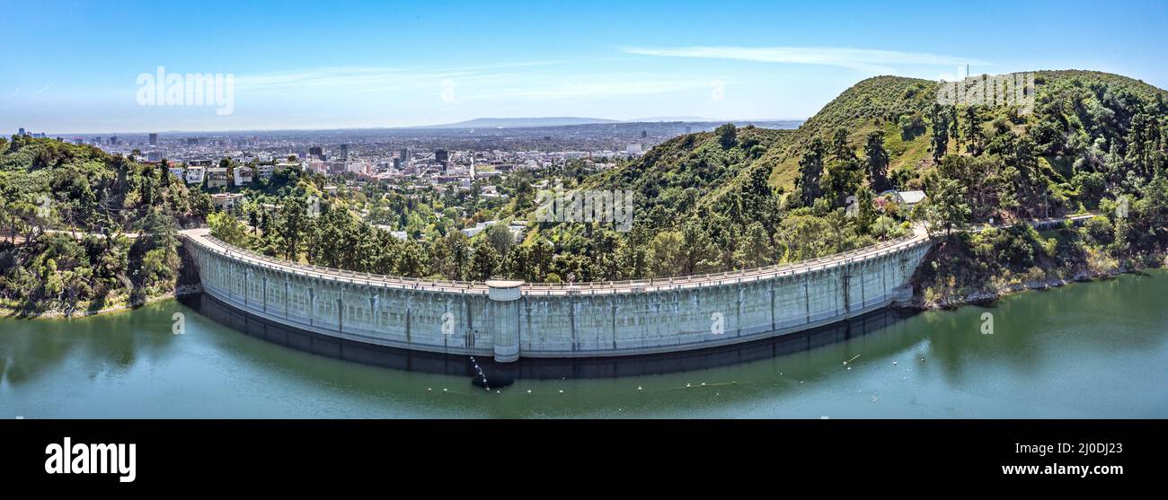 Drone image of Lake Hollywood Reservoir built by Mulholland Dam in 1924 is surrounded by a recreational path for biking, jogging, walking. The dam its Stock Photo