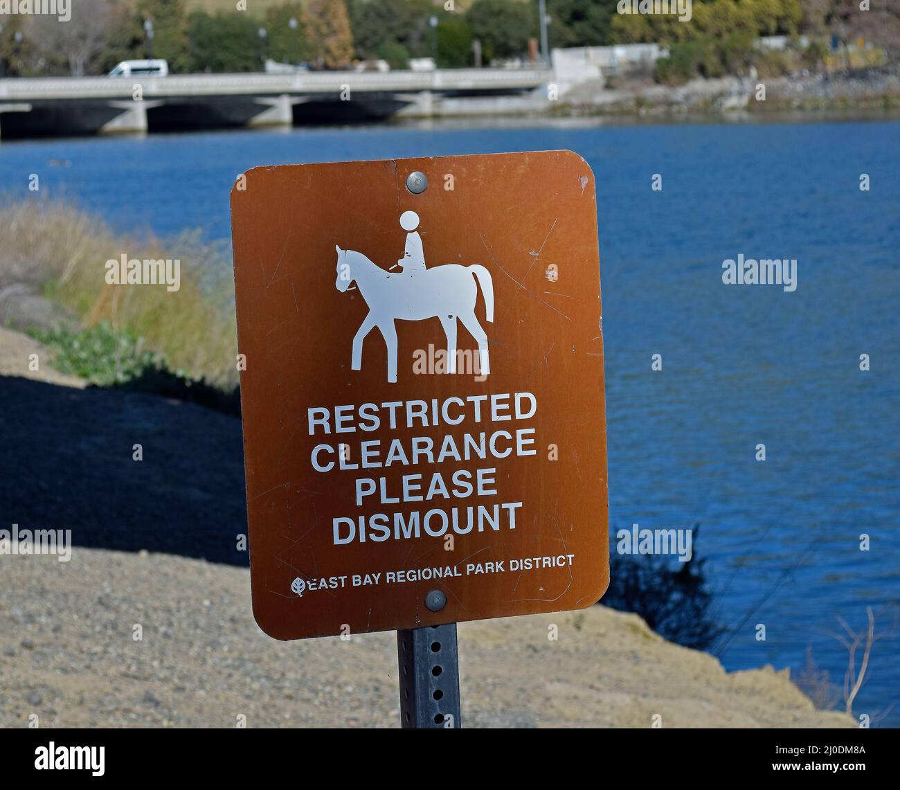 equestrian sign warning of a restricted clearance please dismount on the Alameda Creek Trail, California Stock Photo