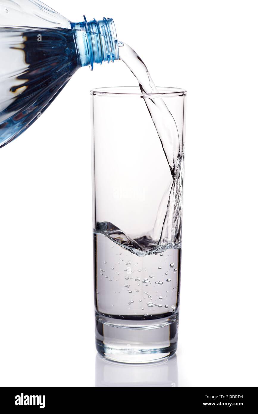 Pouring water from bottle into glass Stock Photo