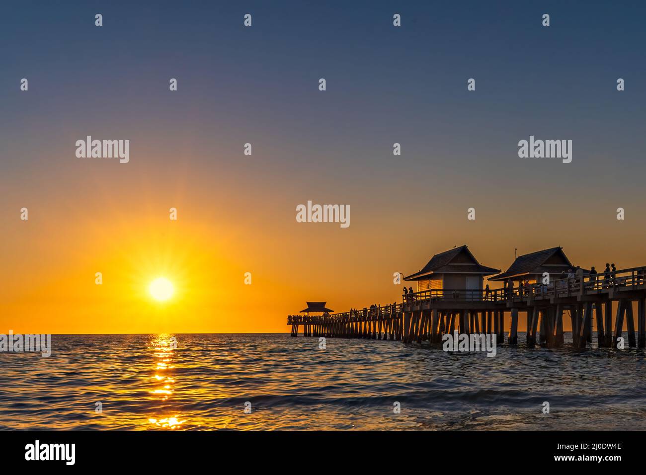 A perfect day comes to a close with a brilliant sunset at the Naples Pier in Collier County, Florida. Stock Photo
