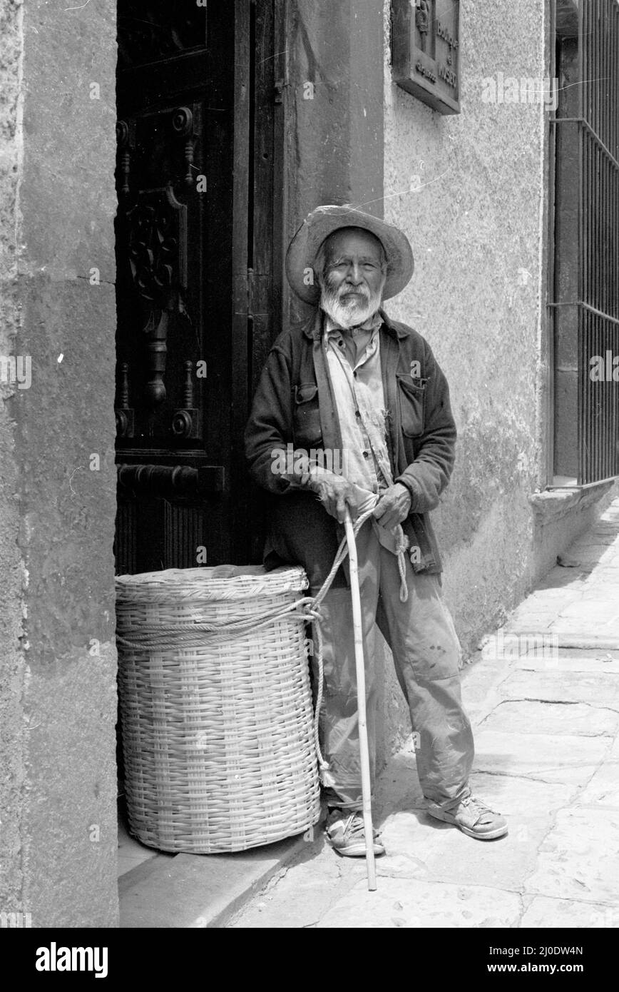 Old black and white photograph of an elderly Mexican man selling baskets in San Miguel de Allende, Mexico Stock Photo