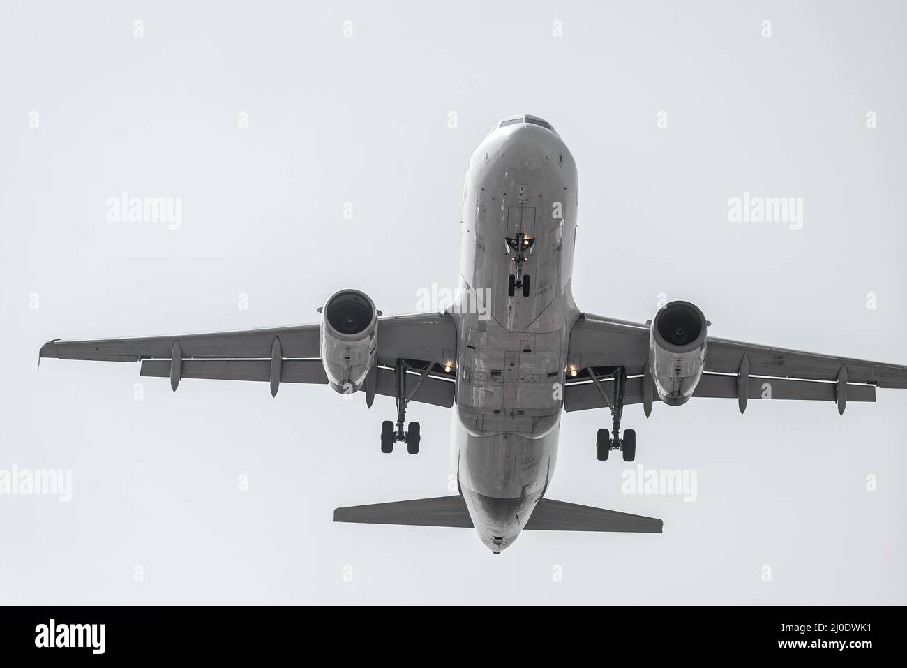Airplane flying high departing from the airport Stock Photo
