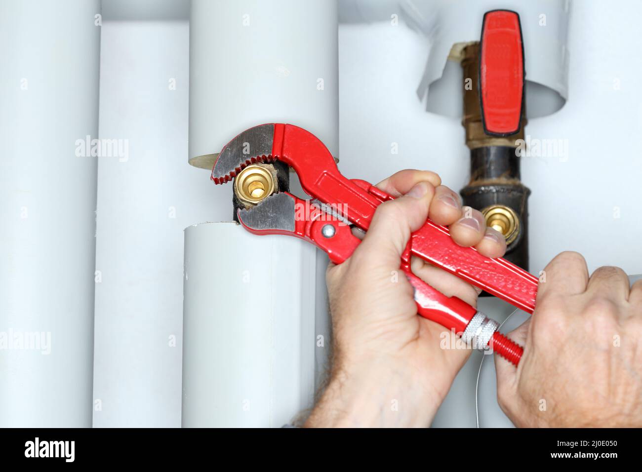 Detail of repairing man with gripper in hand Stock Photo