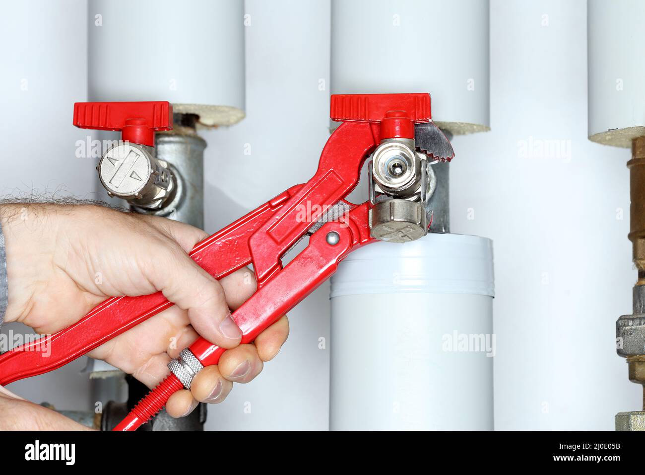 Repairing a valve on a heating pipe Stock Photo Alamy