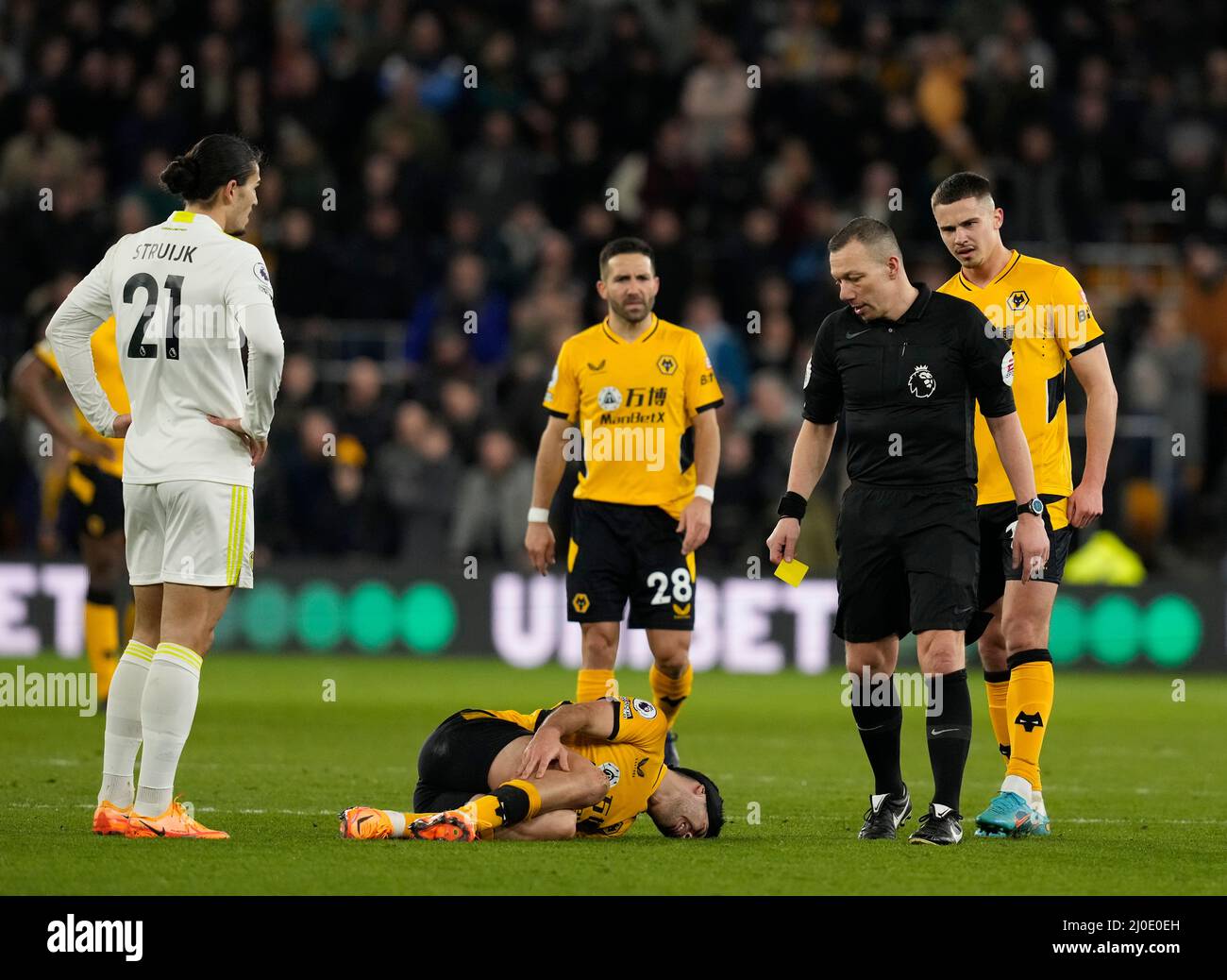 Wolverhampton, UK.18th March 2022.   Referee Kevin Friend waits to yellow card Raul Jimenez of Wolverhampton Wanderers during the Premier League match at Molineux, Wolverhampton. Credit: Sportimage/Alamy Live News Stock Photo