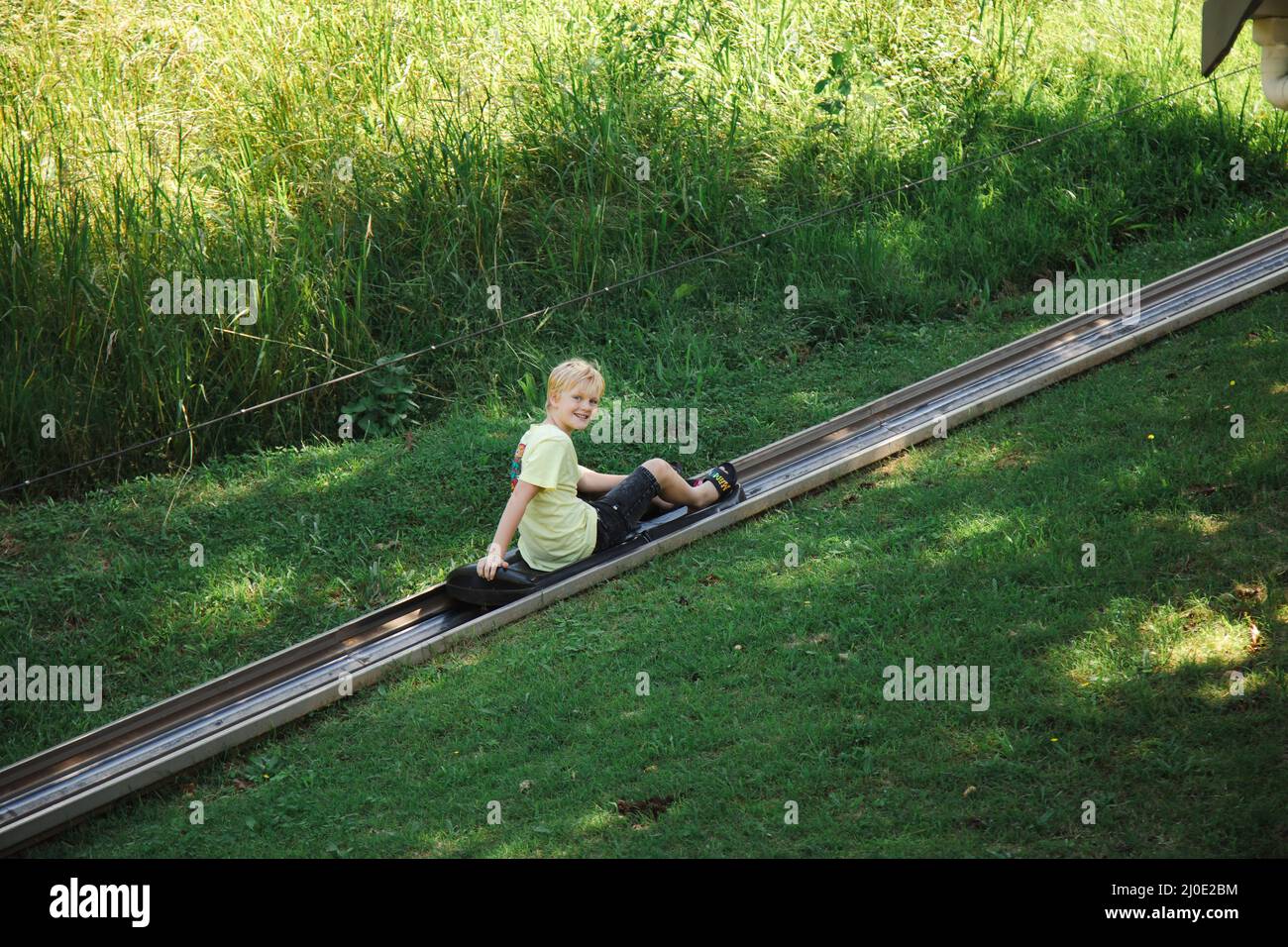 Kids riding the toboggan attraction at the Big Banana Fun Park, Coffs