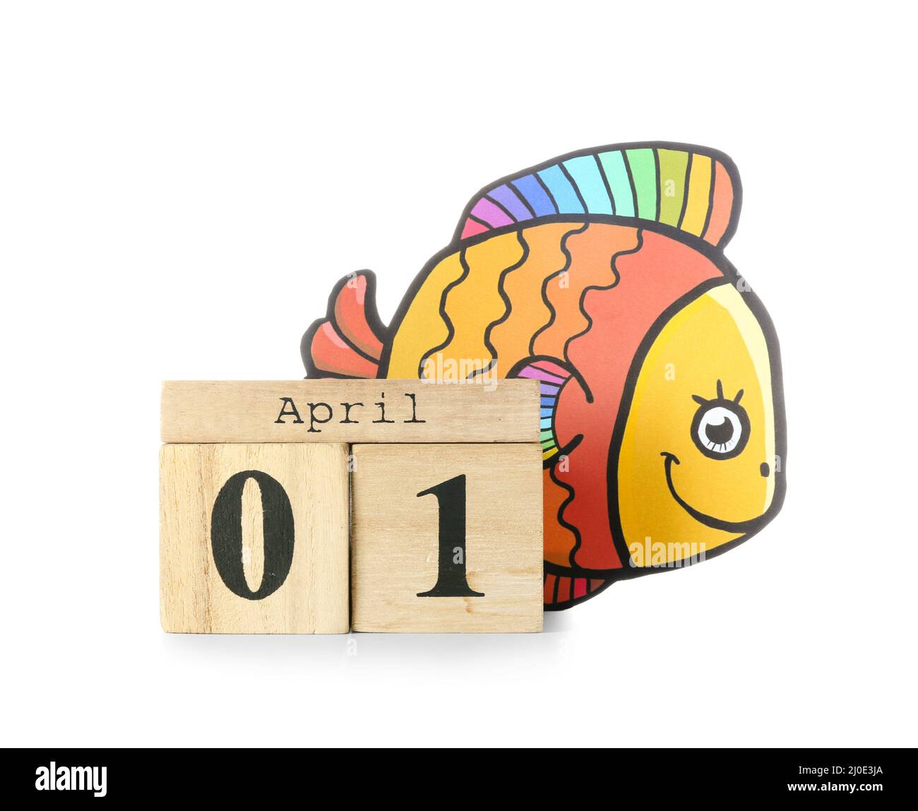 Wooden cube calendar and paper fish on white background. April Fools ...